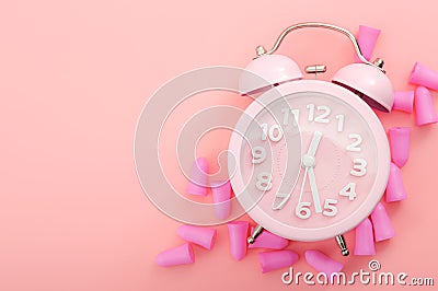 Restful sleeping, wear ear plugs and how to hearÂ the alarm clock without missing sleep due to noise concept theme with earplugs Stock Photo